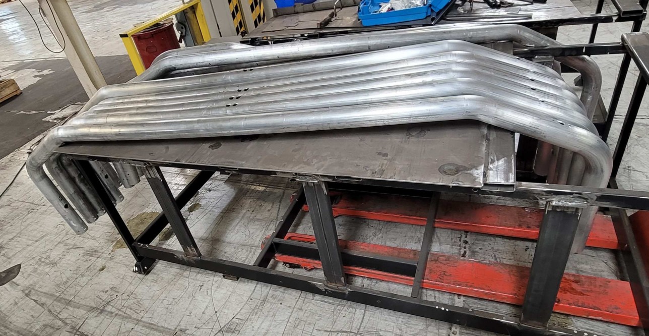 Iowa Metal Fabrication Services Bent Metal Tube Components Fabricated For A Custom Commercial Railing Or Guard Assembly.